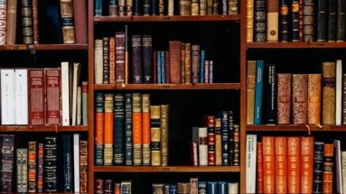 A photo of a bookshelf stacked with older books